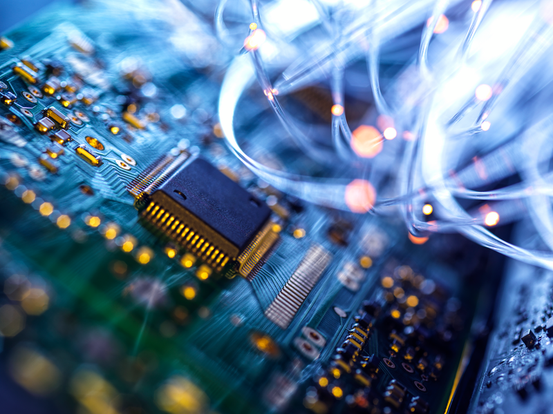 Fibre optics carrying data passing through electronic circuit boards, close up