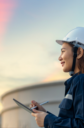 Petroleum oil refinery engineer worker in oil and gas industrial with personal safety equipment PPE to inspection follow checklist by tablet. Classic Energy business concept.